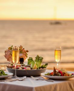 Romantic,sunset,dinner,on,beach.,table,honeymoon,set,for,two