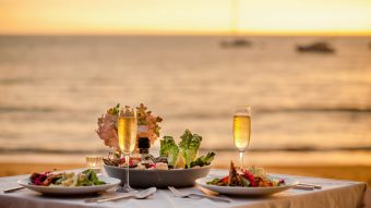 Romantic,sunset,dinner,on,beach.,table,honeymoon,set,for,two