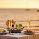 Romantic,sunset,dinner,on,beach.,table,honeymoon,set,for,two